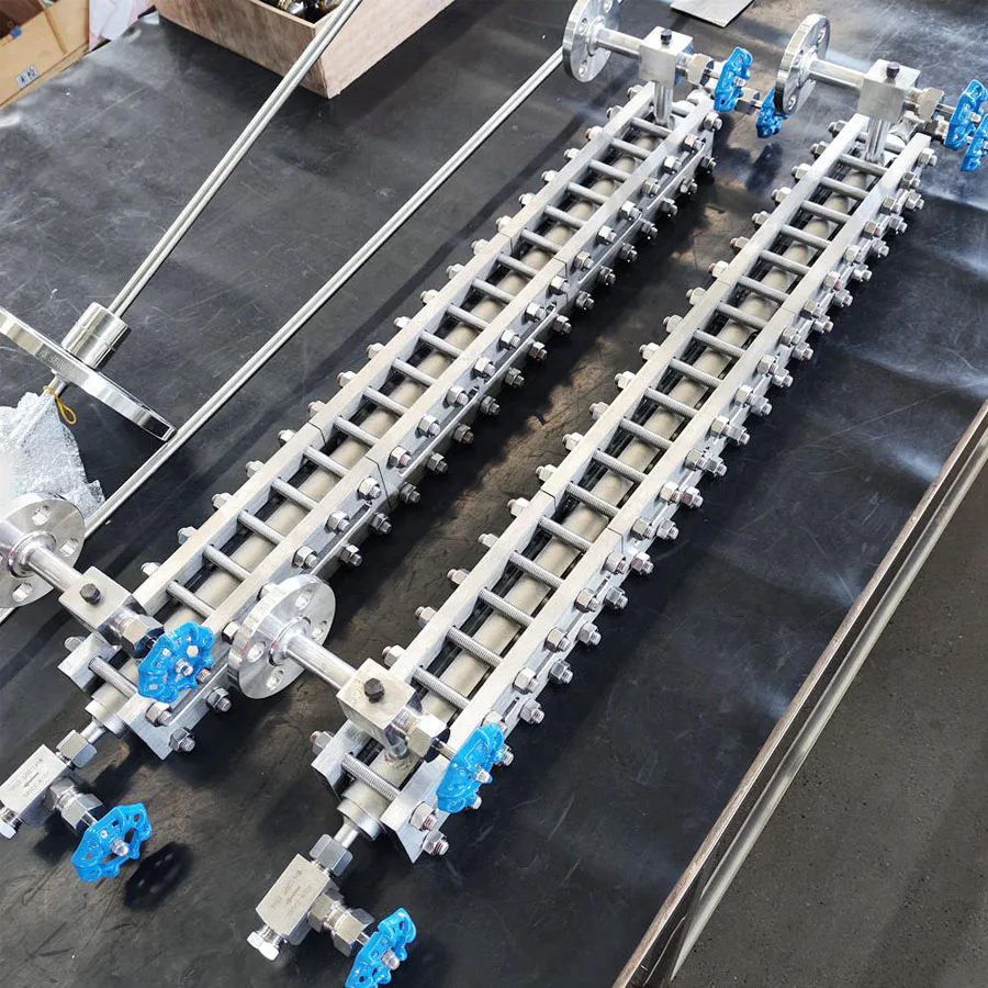 Boiler water level gauge sight glass with blue handwheels and pressure-resistant metal fittings, ensuring clear water level monitoring to prevent boiler accidents.