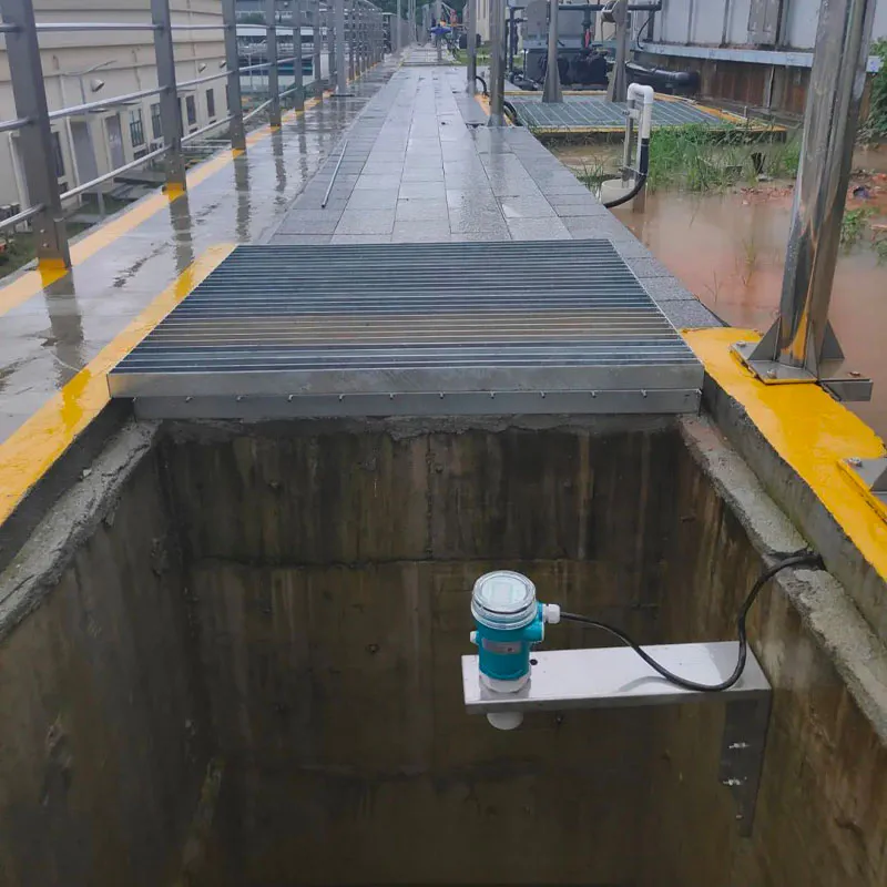 Ultrasonic water level sensor installed in a pit for non-contact continuous water level measurement.