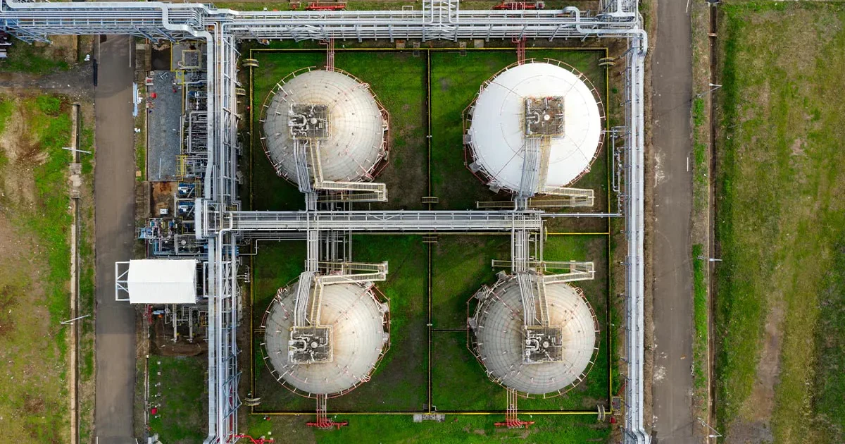 This image shows an overhead view of a water and wastewater treatment plant, featuring multiple storage tanks and piping systems, suitable for level measurement and control applications.