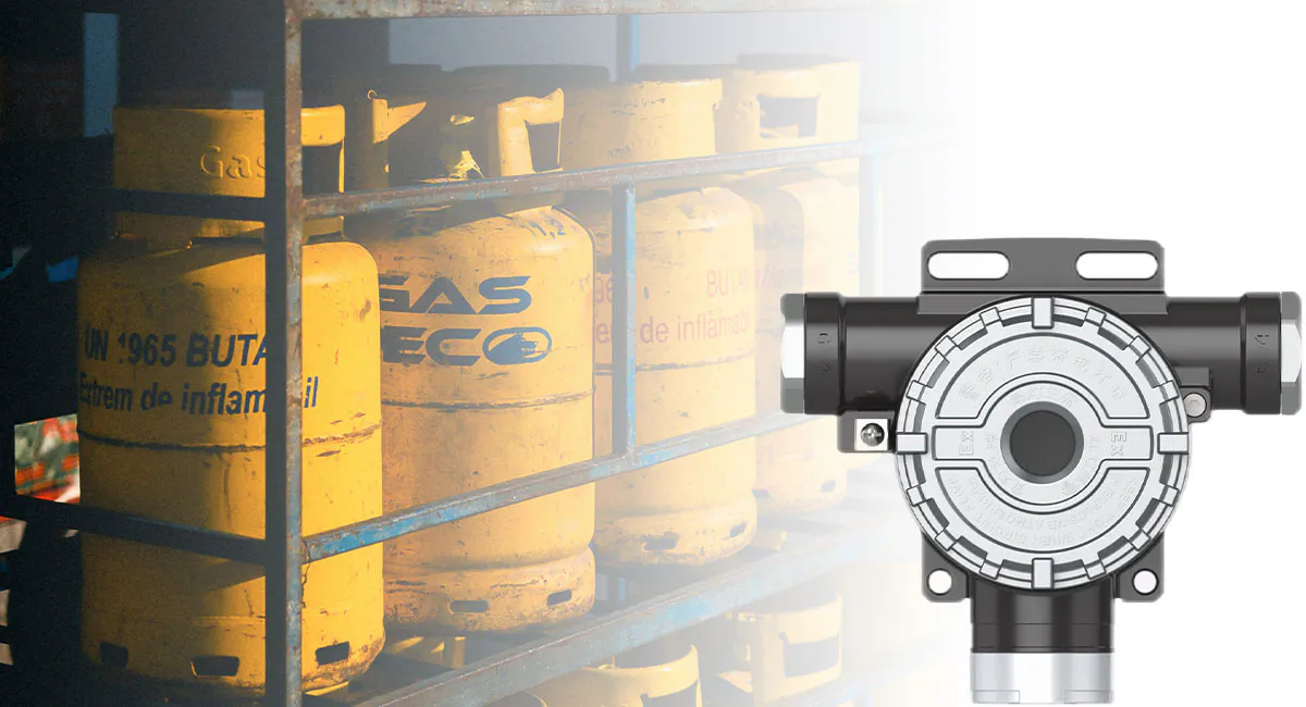 Natural gas and carbon monoxide detector shown with industrial gas cylinder storage in the background, used for combustible and toxic gas leak monitoring