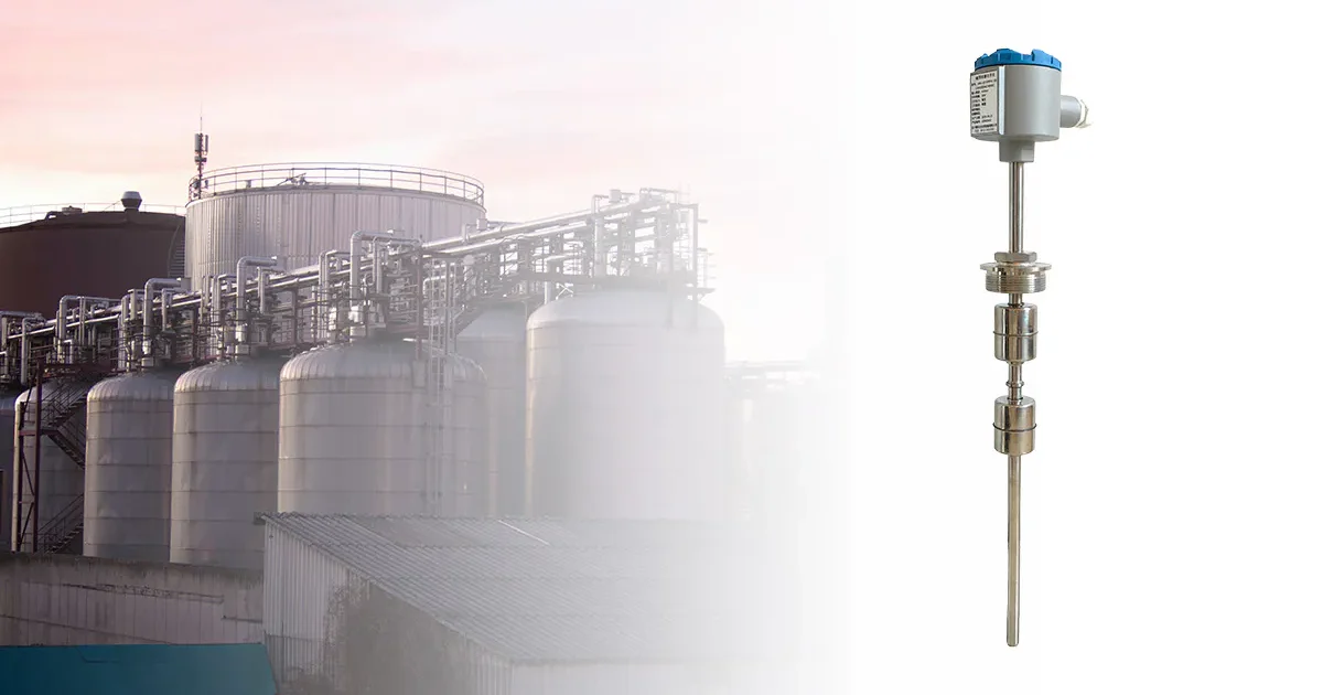 Water level float switch installed in an industrial tank setting with pipes and storage tanks