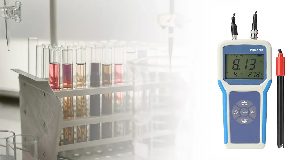 Digital pH meter for laboratory testing with multiple test tubes in the background.