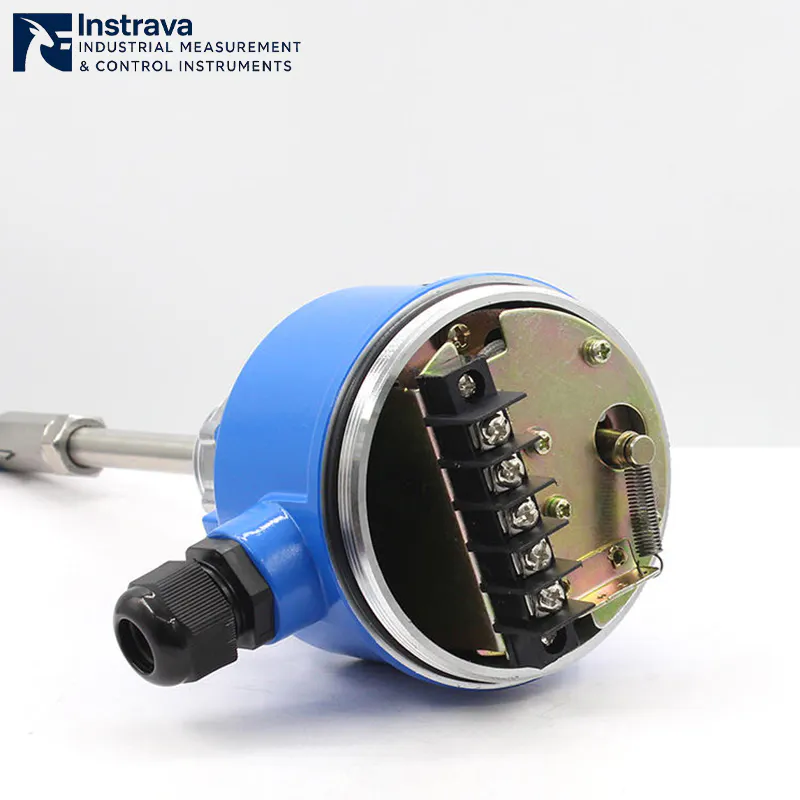 Internal wiring structure of a rotary paddle level switch, showcasing the rugged circuit board, terminal blocks, and reset spring mechanism.