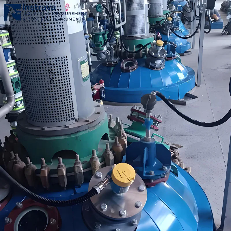 Real-world installation of a side-mounted float level switch on a storage tank for industrial liquid point level detection and overflow alarming.