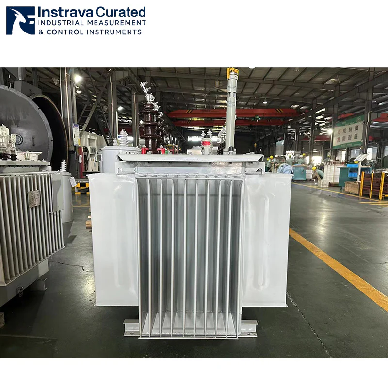 Oblique view of distribution oil-immersed transformer in factory, showing corrugated cooling radiators, conservator tank and high/low voltage bushings, for industrial distribution and substation applications