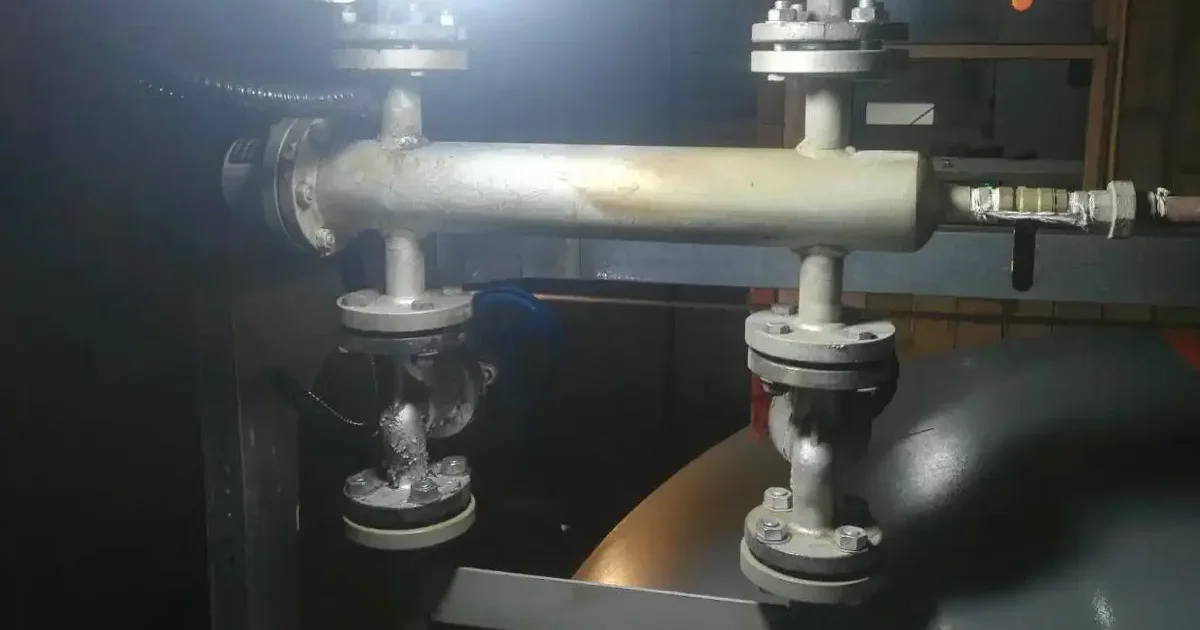 Electrode-type boiler level sensor installed on steam boiler piping system for water level monitoring and control