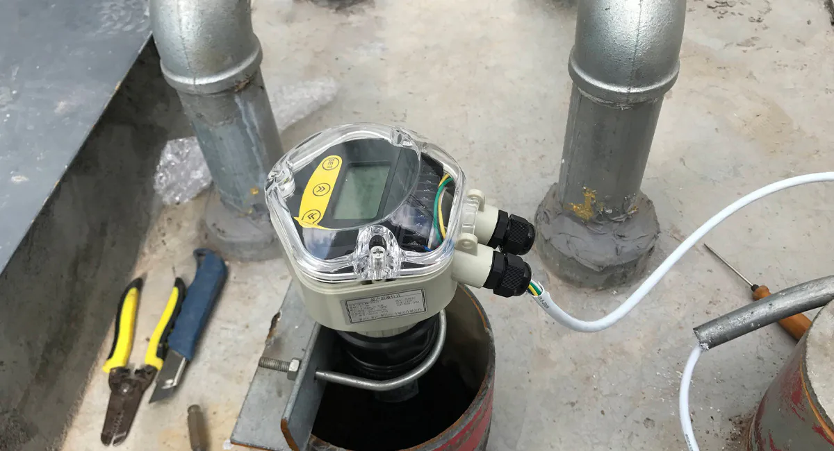 Ultrasonic level transmitter installed on a tank for continuous liquid level monitoring in industrial applications