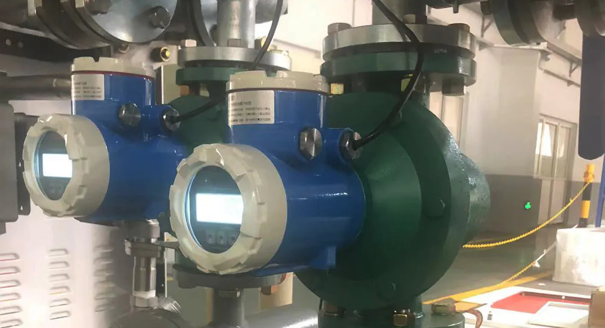 Oval gear positive displacement flow meter installed in industrial pipeline for precise liquid flow measurement