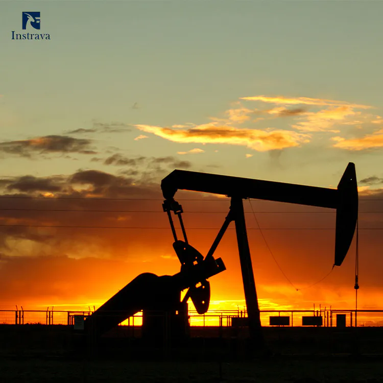 Oil pumpjack operating at sunset, representing flow metering solutions for oil and gas extraction.