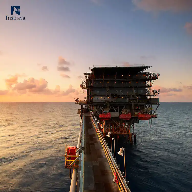 Offshore oil & gas production platform standing on open sea at sunset, Instrava industrial flow, pressure and level measurement instruments application scene for marine offshore energy exploitation industry