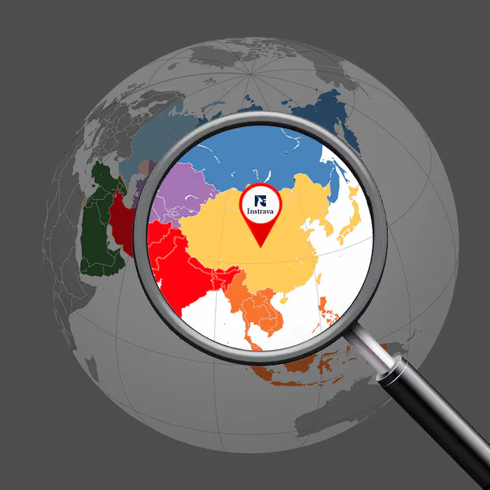 Magnifying glass highlighting China on a world map, representing Instrava as a China-based level gauges supplier for global industrial markets.