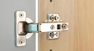 Concealed cabinet hinge installed on a wooden cabinet door and frame
